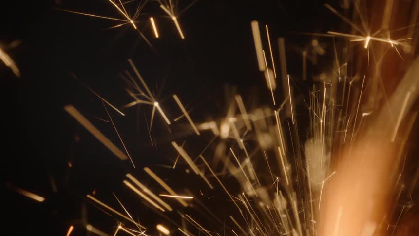 Sparks fly in a dark room