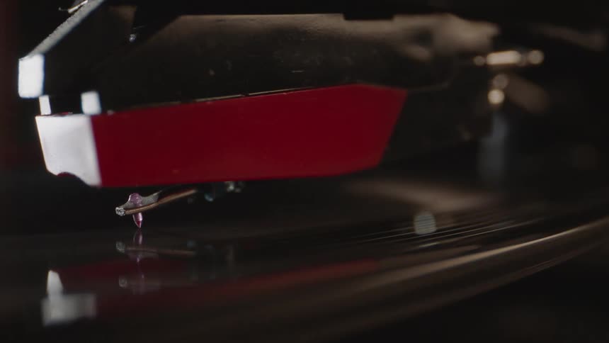 A record player has a record spinning on it