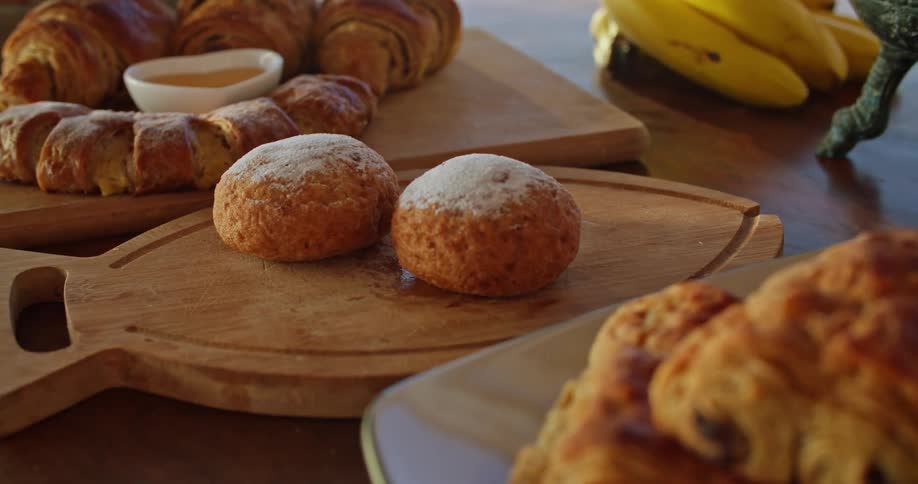 Pastries and croissants are displayed on tabletop