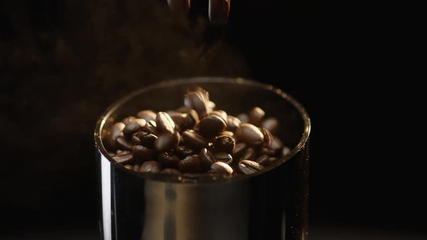 Coffee beans are being poured into a machine
