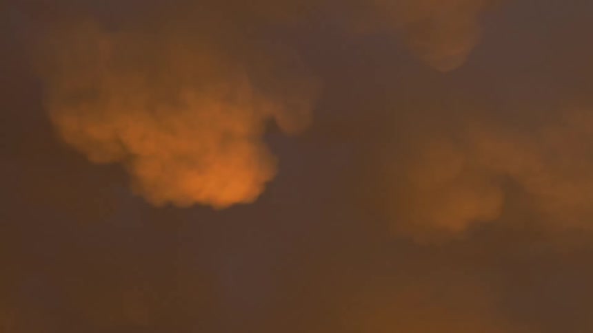 Heavy smoke and fog fill the sky