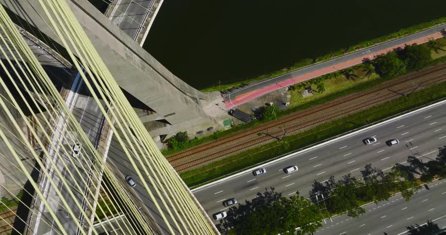 Aerial view of vehicles driving on the ramps of a bridge passing over a highway