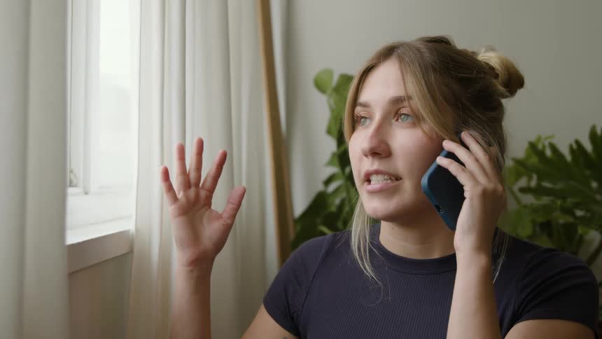 A woman is talking on her cell phone