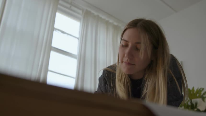 A woman is writing with a pen