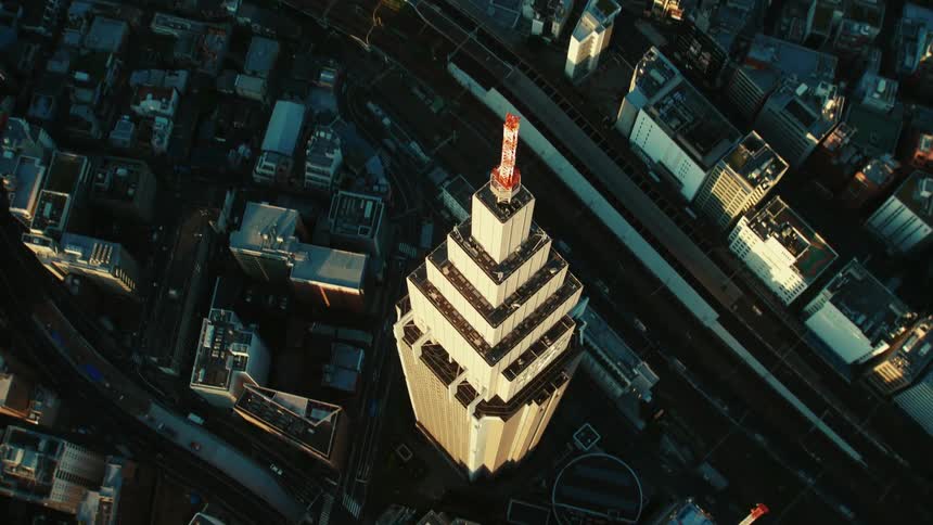 An aerial view of a tall tower in a large city