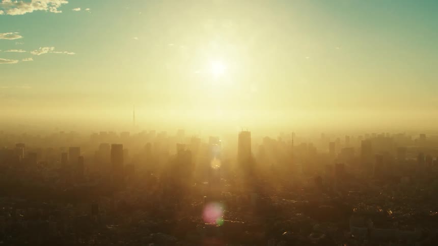 An aerial view of buildings and skyscrapers on a hazy day