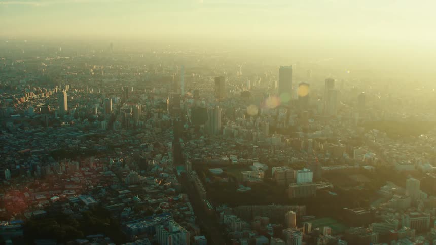 Aerial view of morning shining over high rise buildings and houses in the city