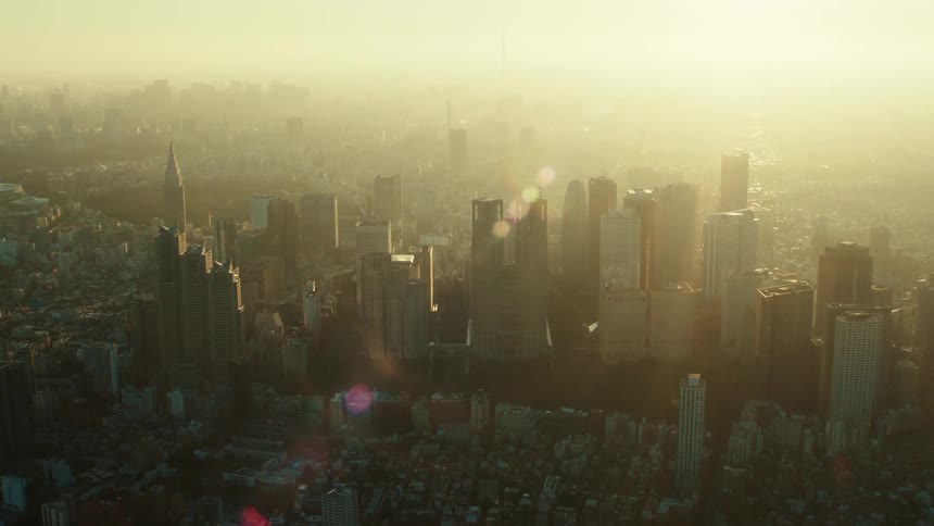 Sun turns thick haze yellow as it obscures city between downtown skyscrapers and the horizon