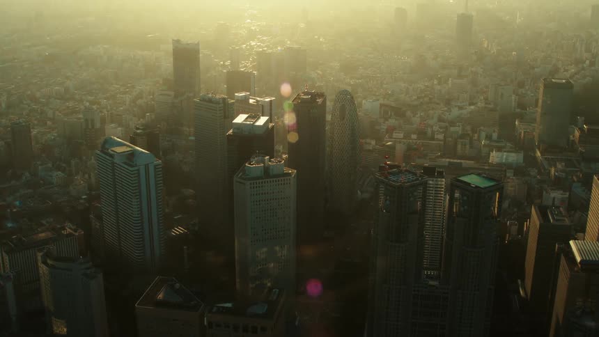 An aerial view of skyscrapers in a city on a sunny day