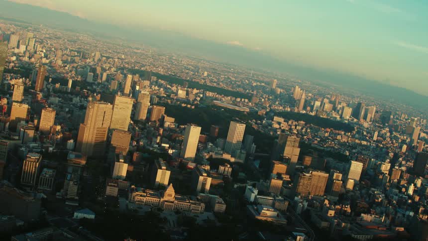 Thick smog hovers over a city filled with tall skyscrapers