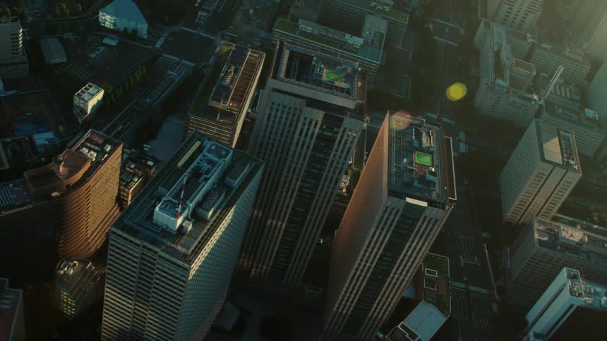 Rooftops of city buildings and skyscrapers with sunlight glaring