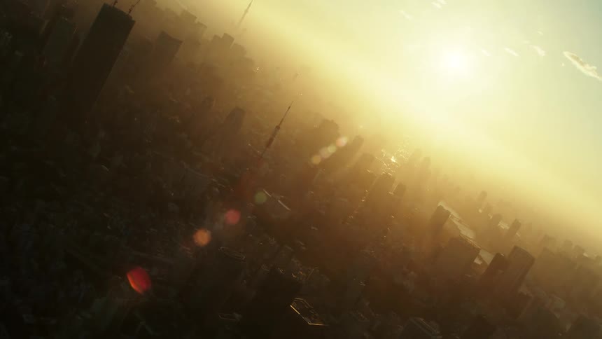Aerial view of sun rising and shining brightly over city with skyscrapers and high rise buildings