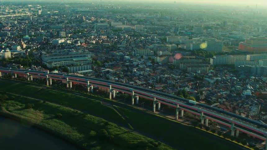 Cars and trucks traveling on an elevated highway in a large sprawling city