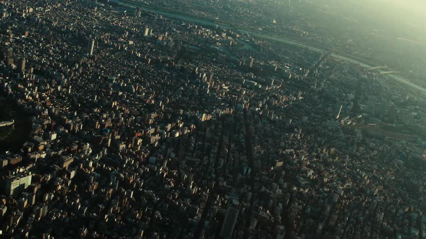 A sprawling city divided by a river with several bridges