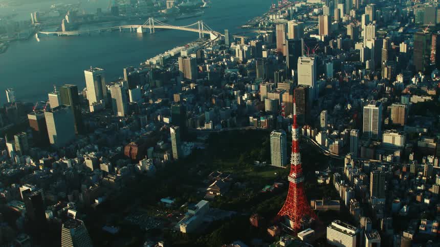 An aerial view of high rise office buildings in a city with a river running through it