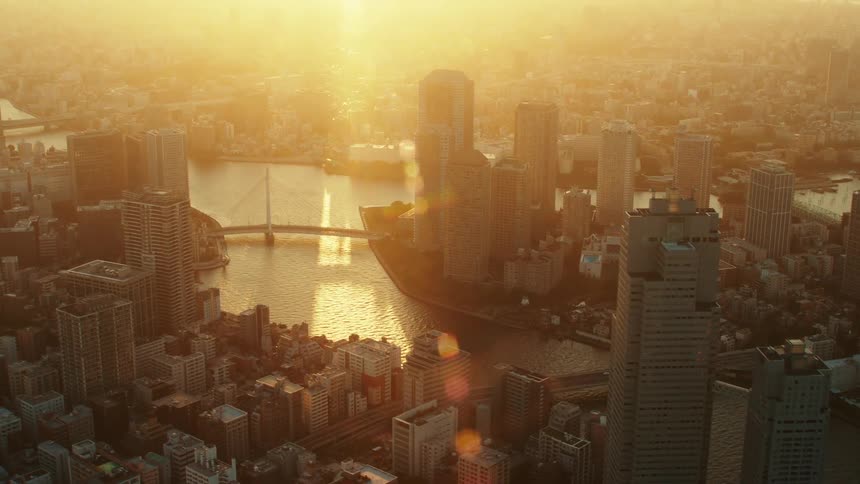 An aerial view a river running through a city filled with high rise office buildings