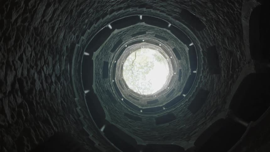 A stone staircase spirals overhead