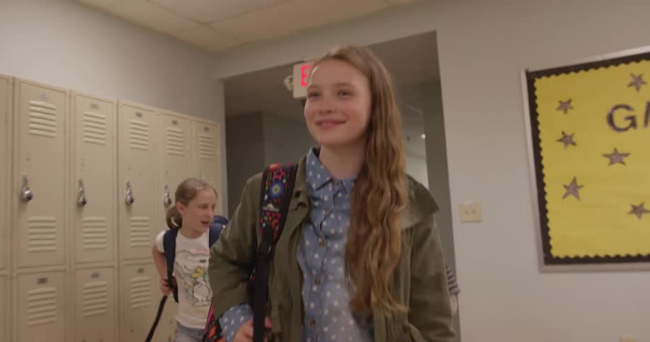 School children walk down a hallway