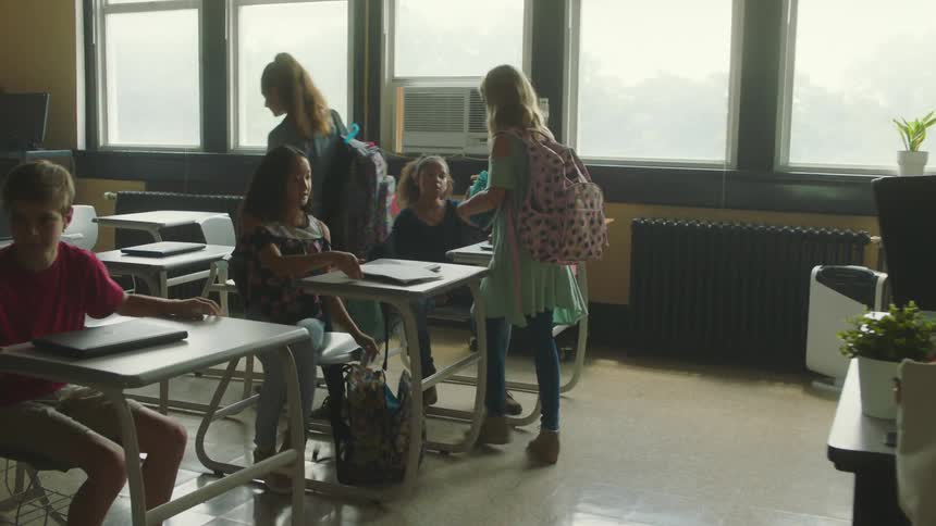 A school teacher walks down the hall