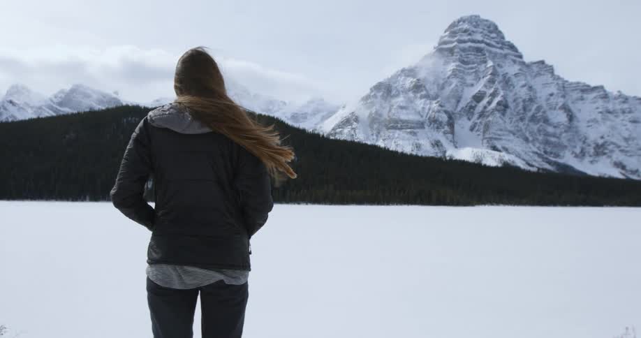 A woman standing in a snow-covered field