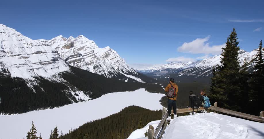 Group of people overlook a snowy mountain range