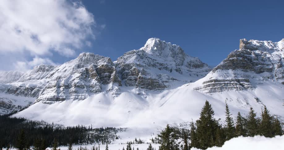 A large mountain range is covered with snow