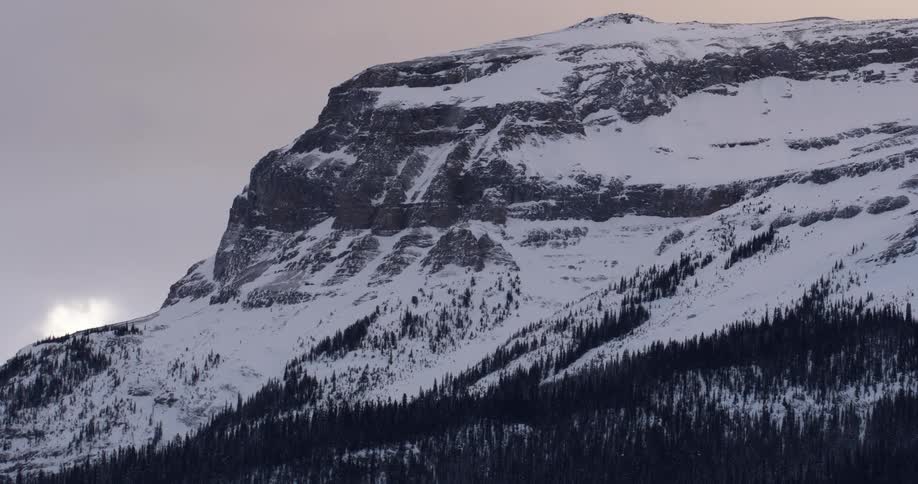 A snow covered mountain on a cloudy day