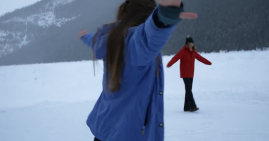 Women are sliding and dancing in the snow