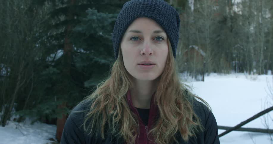 A woman breathes air in cold weather