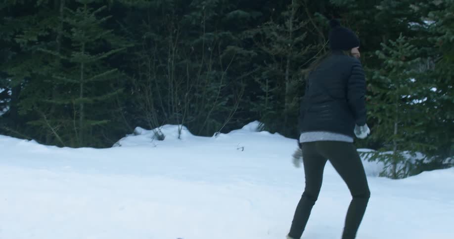 A woman is throwing snowballs