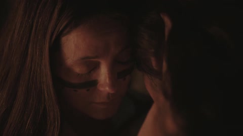 A man and woman touch foreheads