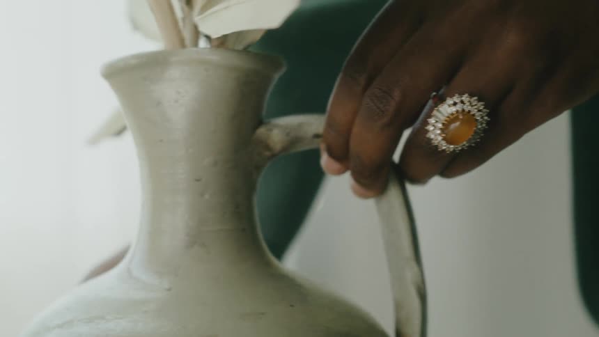 A person is placing a vase with flowers