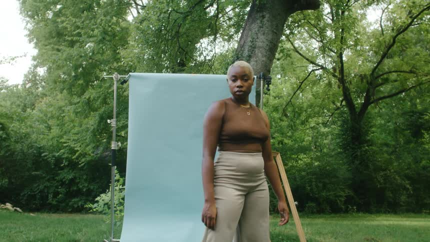 A woman is standing outdoors in the spring time