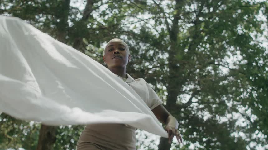 A woman is waving a white sheet