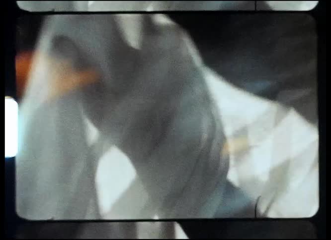A person is moving their hands around inside a sheer fabric