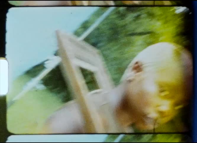Film footage of a woman standing outdoors during spring