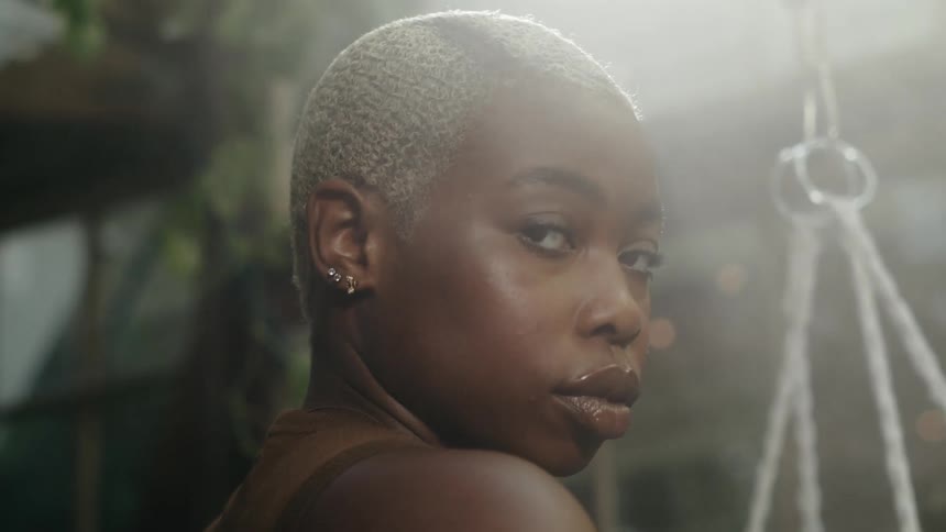A woman outside turns and looks to the side of her