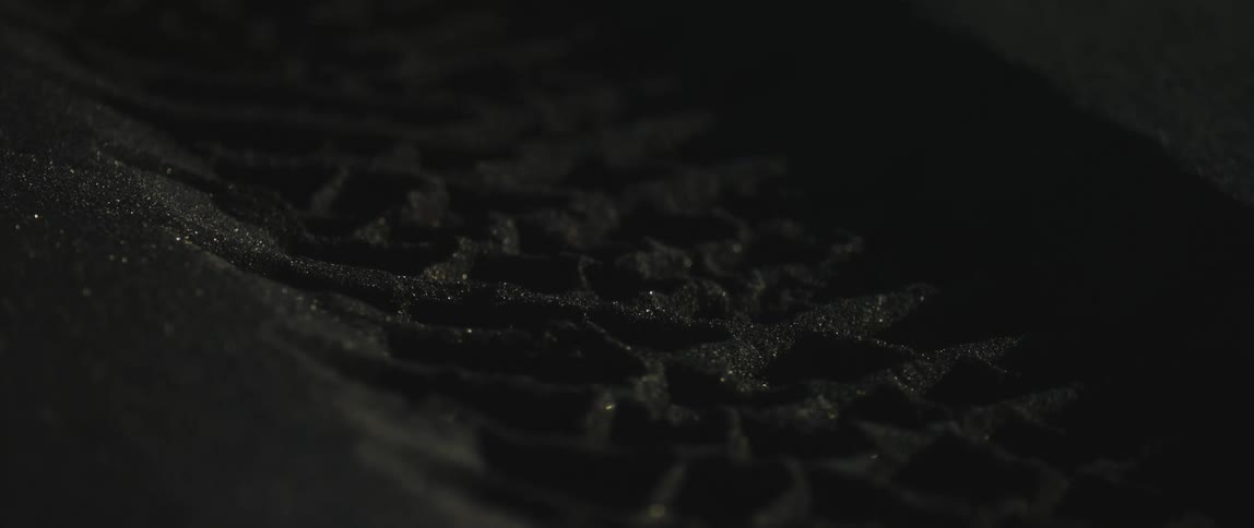 Close up view of dirt on the ground at night is displayed