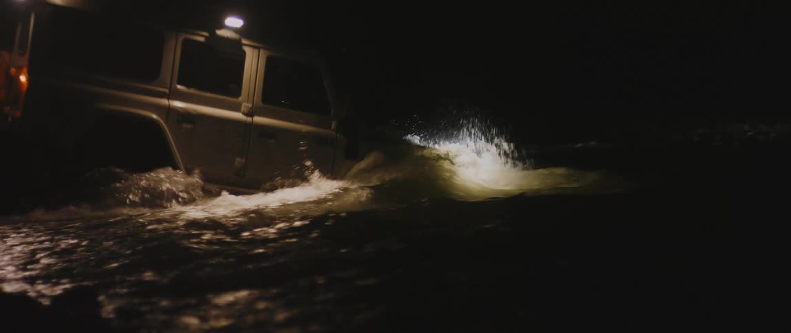 A view of a car driving into a river
