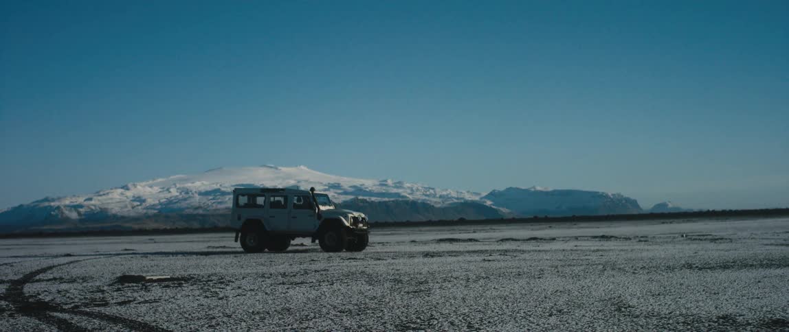 A car is driving off road in winter