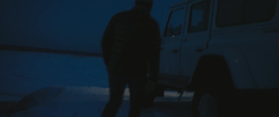 Two people are walking towards their parked car