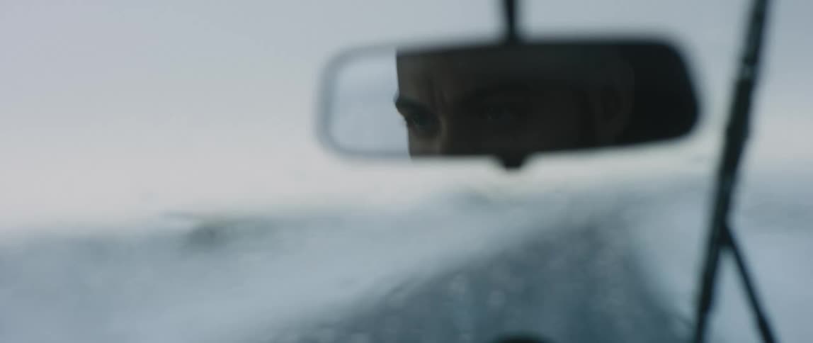 Man travels in a vehicle with moisture on the window