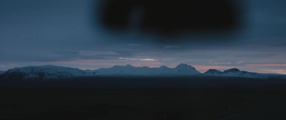 Aerial view of a landscape at dusk is displayed