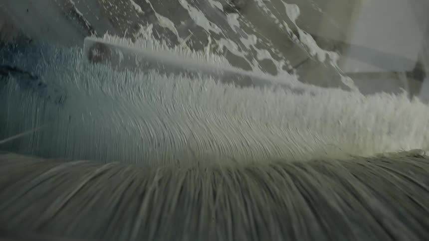 The bristles of a paint brush are leaving a texture on wet paint
