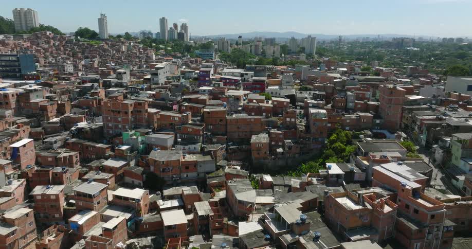 Arial view of a crowded city with buildings close together and tall buildings and skyscrapers in the distance