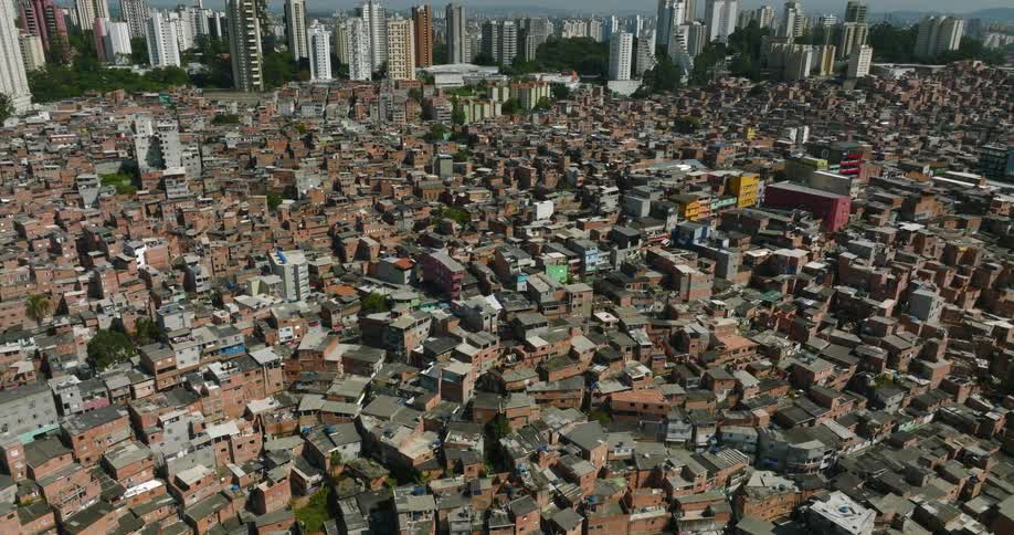 An aerial view of a housing in a neighborhood with the city skyline in the distance