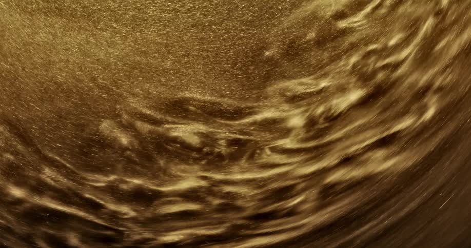 Golden grains of sand swirl