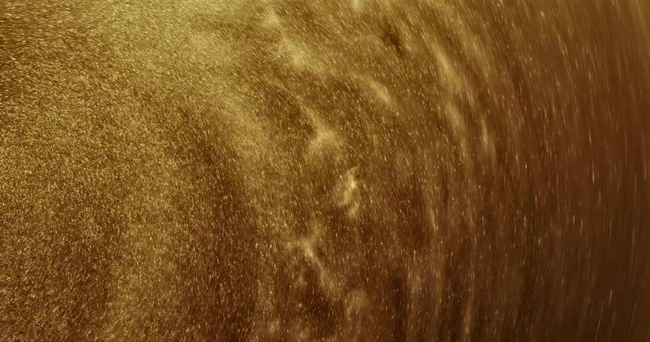 Golden grains of sand swirl