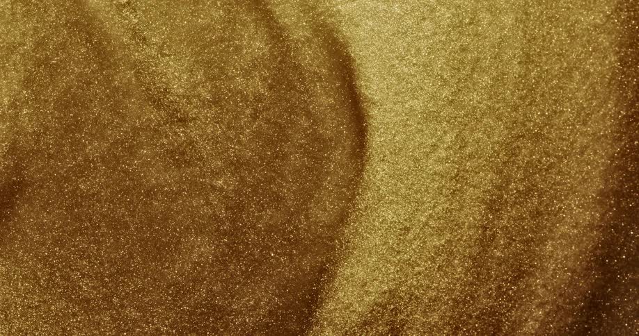 Golden grains of gold swirl and surges