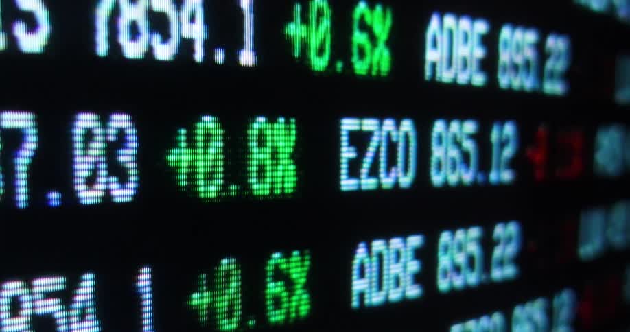 Close up of a large digital display with stock market values moving horizontally